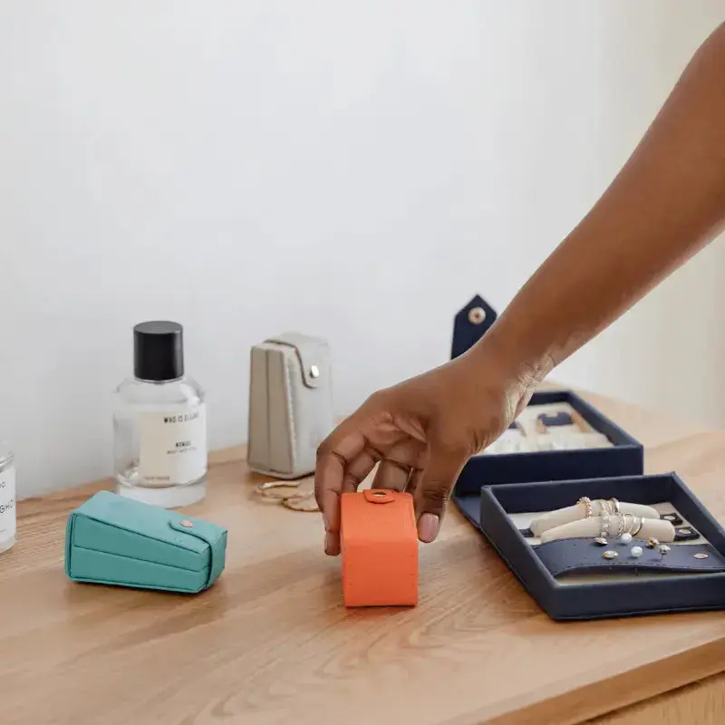 Person picking up a mini travel jewellery box