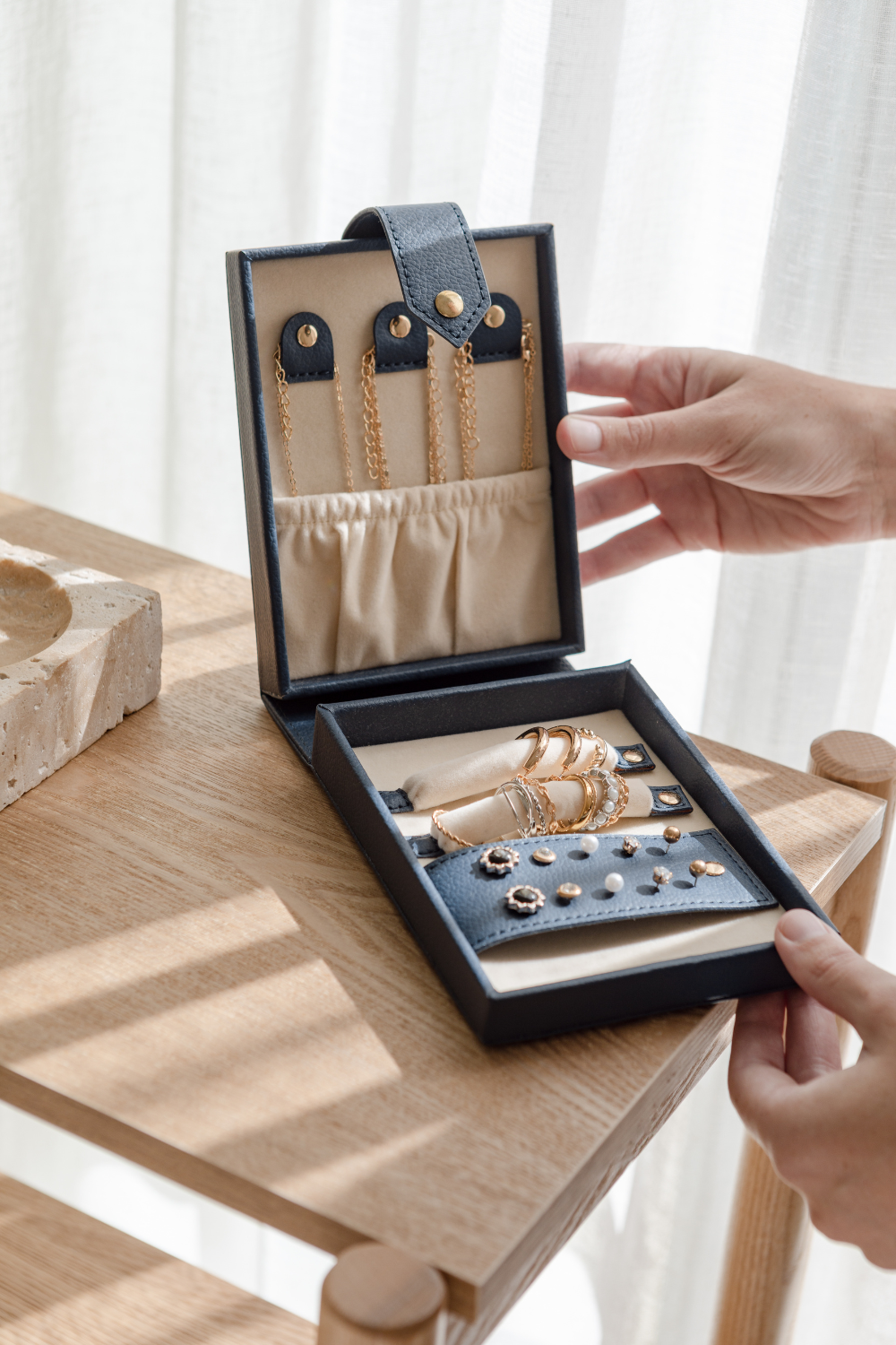 Woman opening travel jewellery box